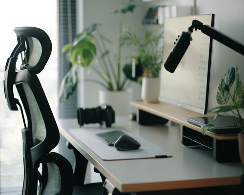 A clear diagram-like clean shot of an organized desk setup emphasizing ergonomic comfort
