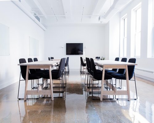 An organized conference table inside a quiet minimalist editorial office workspace
